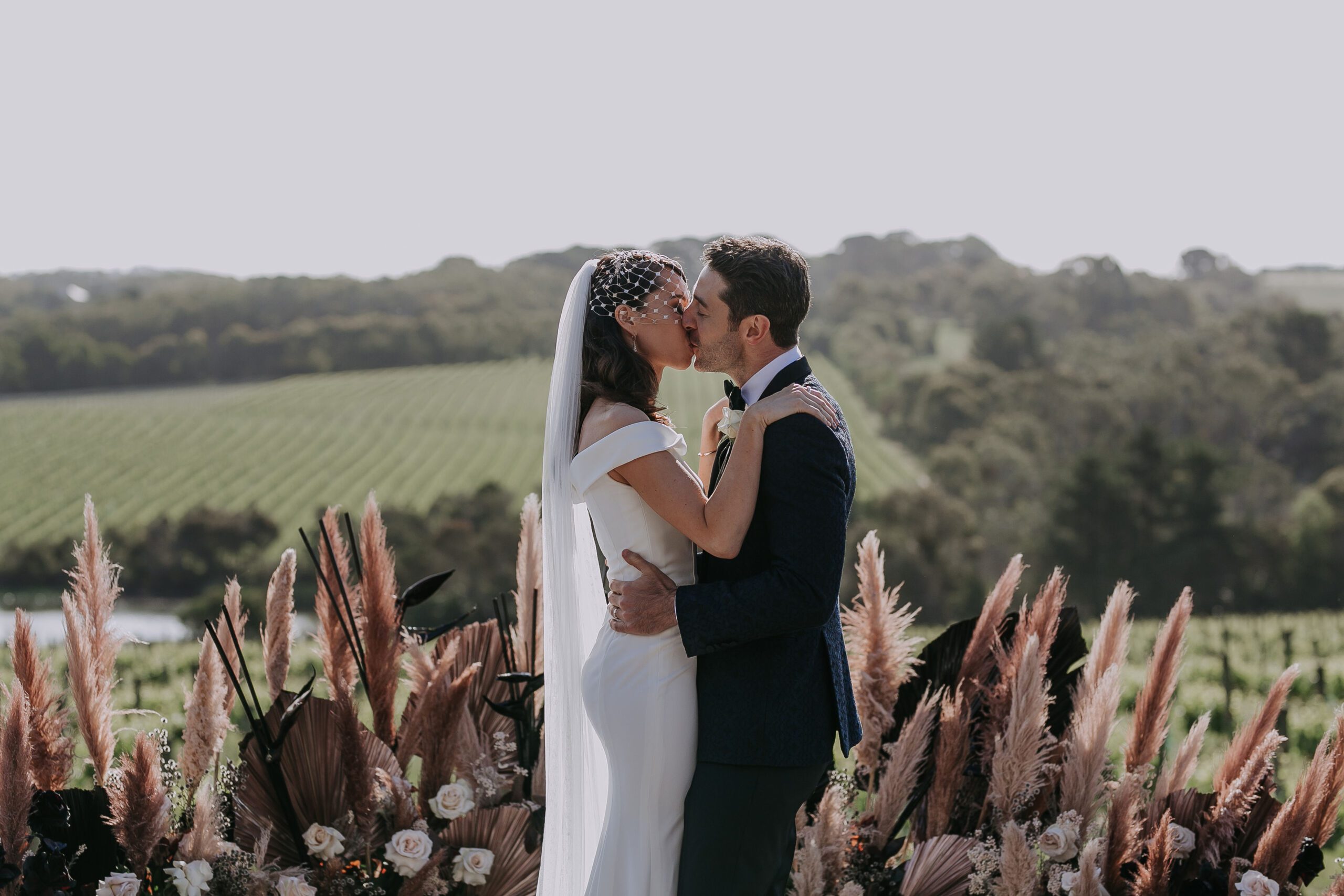 Couple sharing ceremony kiss at Jackalope Hotel vineyard luxury wedding